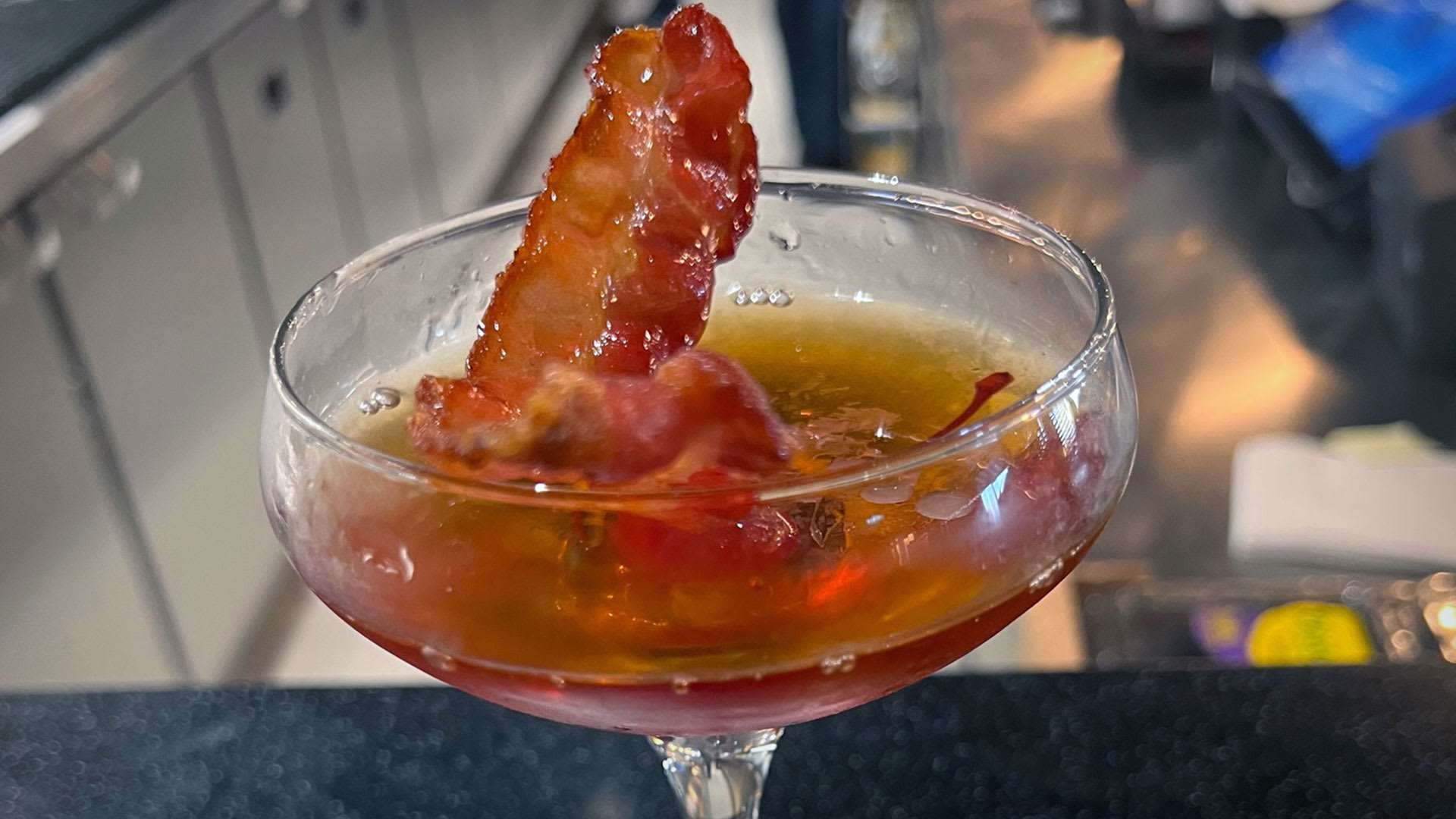 A Manhattan with a piece of candied bacon at Mason Jar on Wonder of the Seas. Mason Jar on Wonder of the Seas Lead JS