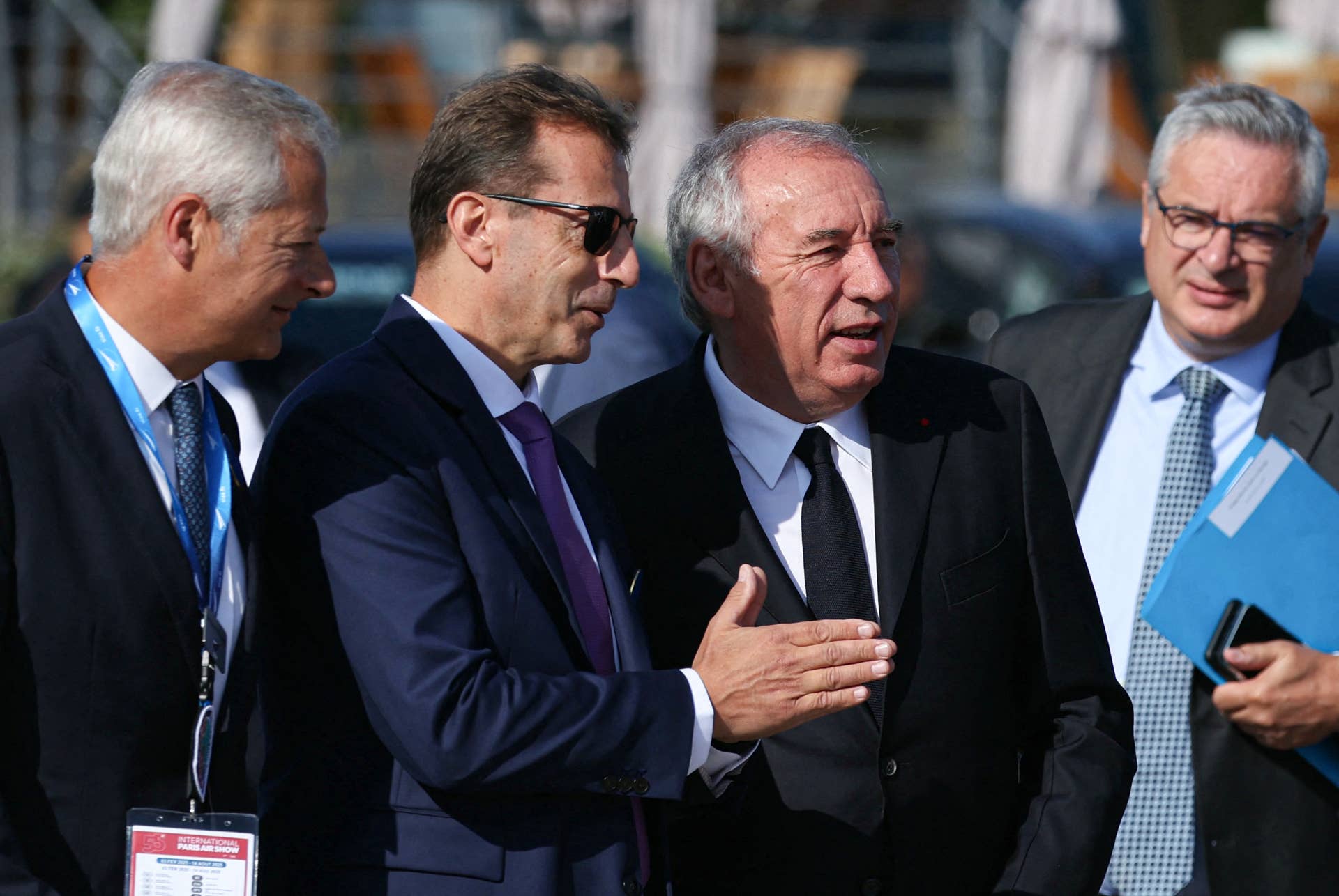 France's Prime Minister Francois Bayrou (2nd R) is greeted by Airbus CEO Guillaume Faury (2nd L).